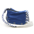 Blue soft sling bag side view with striped accents and metal grommets