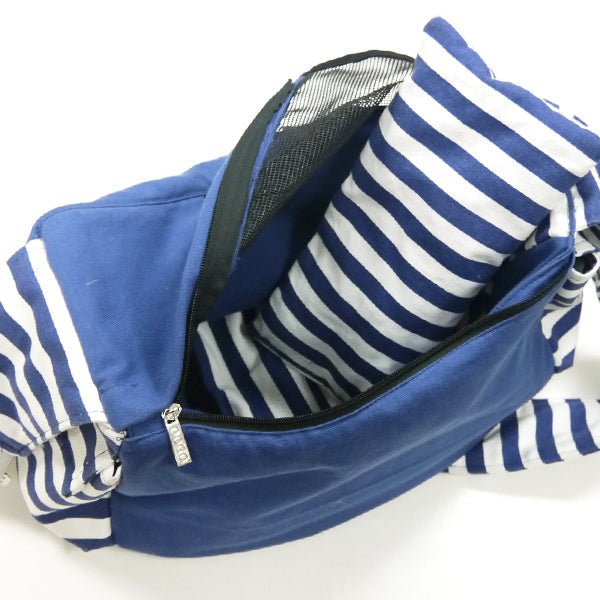 Soft sling bag in blue with striped fabric lining and zipper top opening