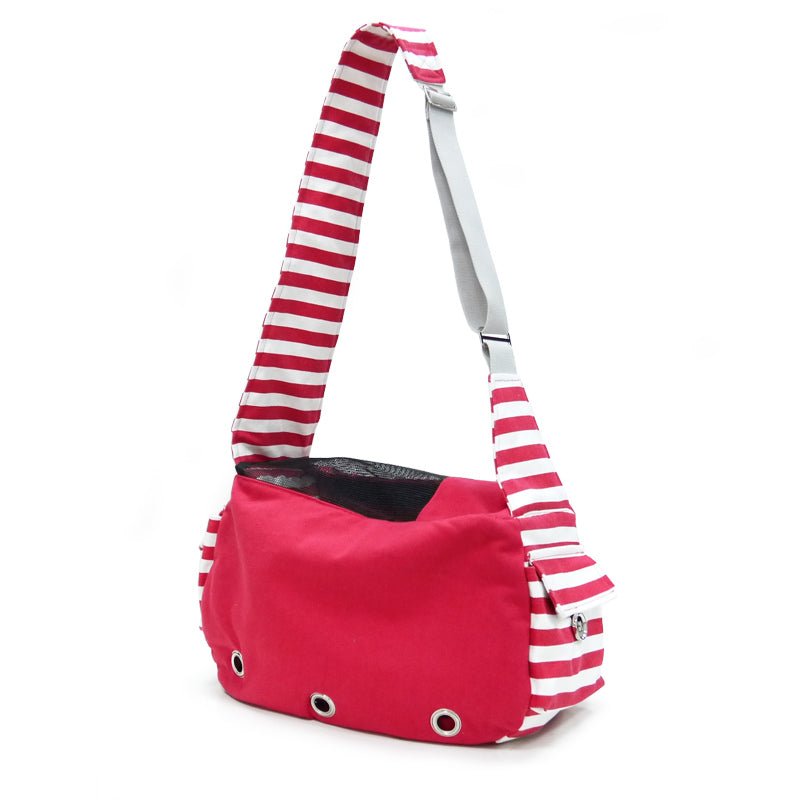 Soft sling bag in red with white-and-red striped strap and small metal eyelets on front