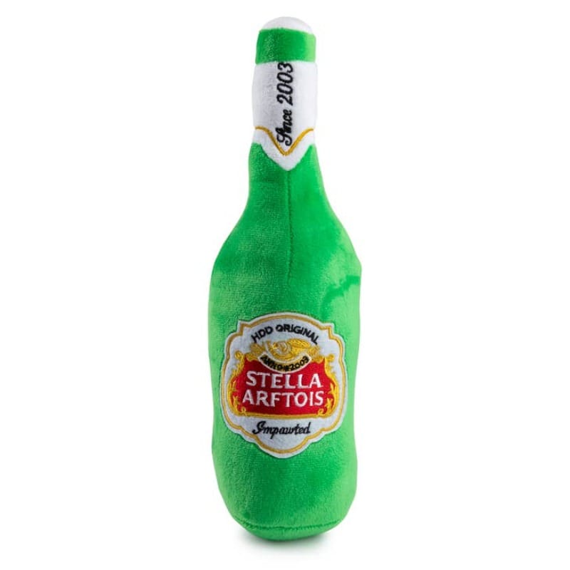 Green plush bottle-shaped dog toy with printed Stella Artois label.