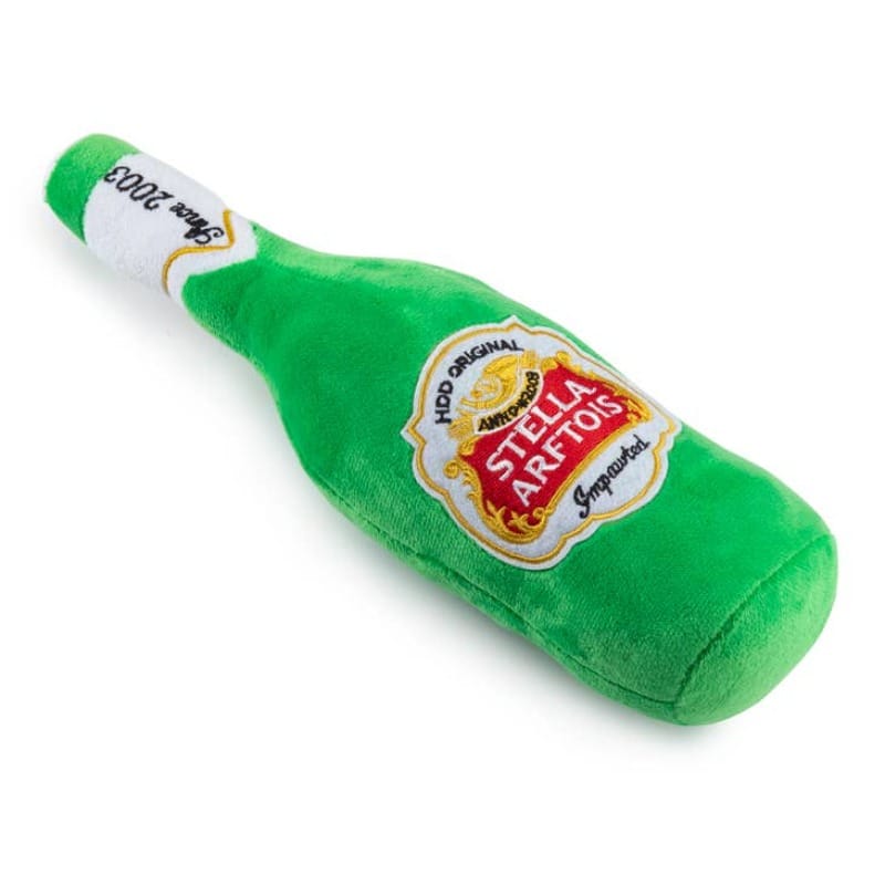 Green plush bottle dog toy with white neck and Stella Artois crest patch.