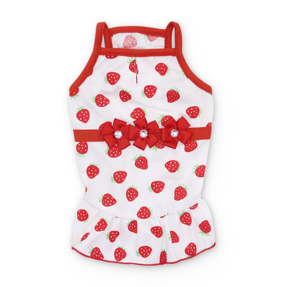 White sleeveless dog dress with red strawberry print, red bow at chest, and peplum hem