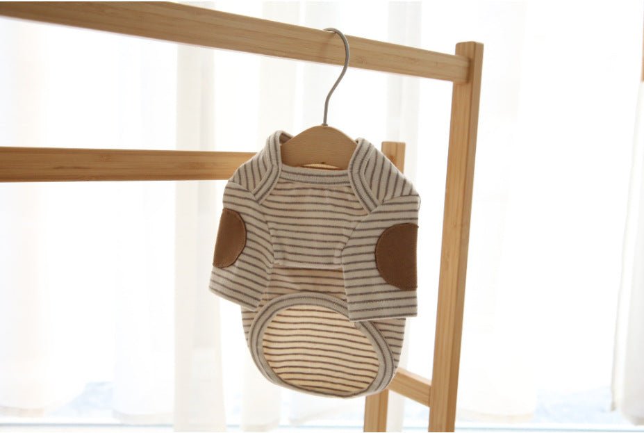Beige striped dog base-layer hoodie on hanger with brown paw-patch accents and hood
