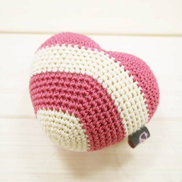 Pink and cream striped crochet heart toy, side view