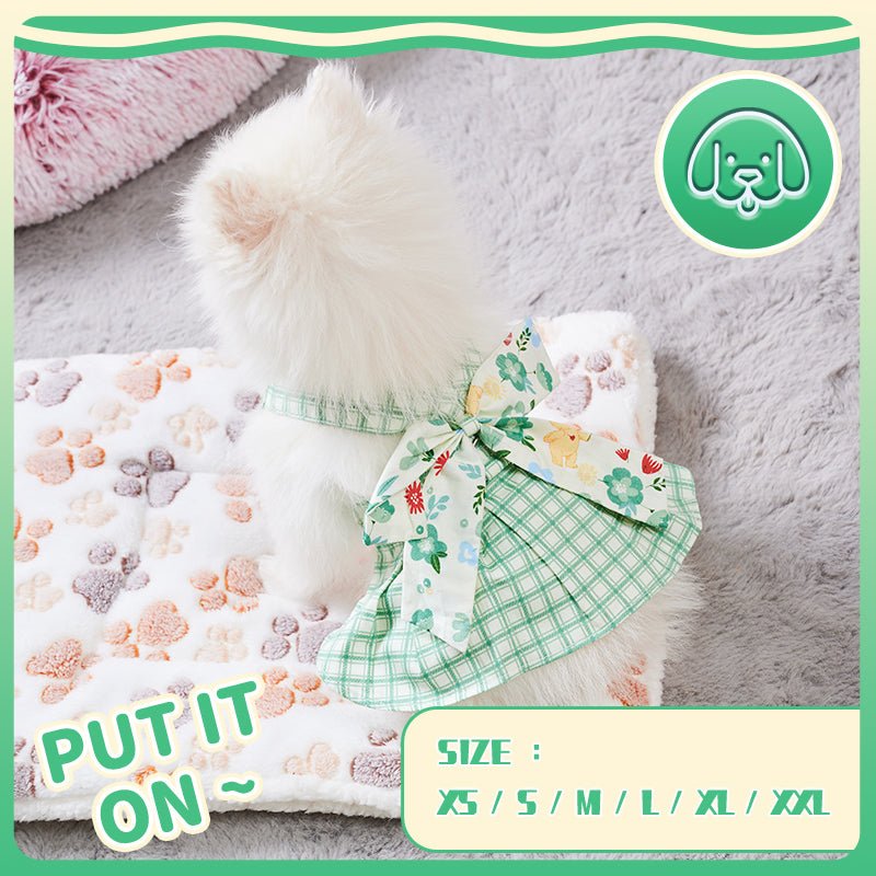 Dog harness dress with green plaid skirt and floral ribbon bow at the chest