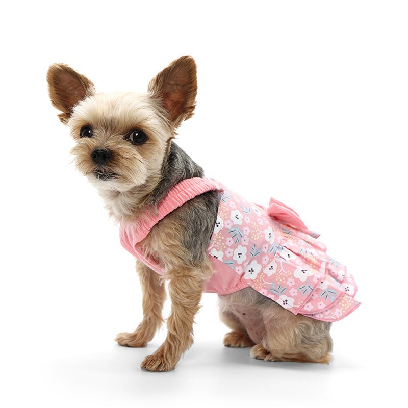Pink patterned pet dress with bow at waist and layered ruffle skirt, side view