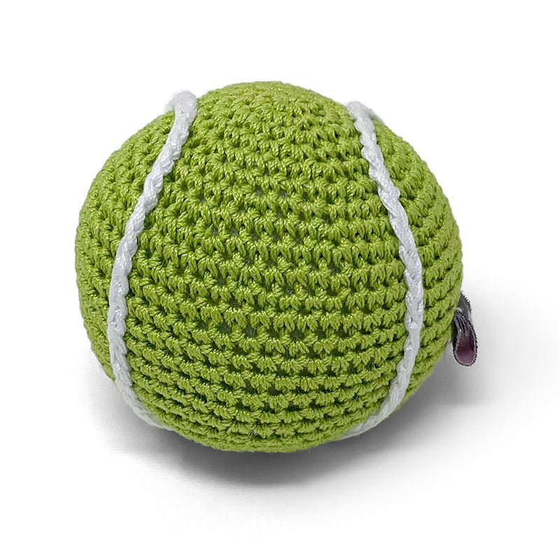 Green crocheted tennis ball toy with white seams and small purple tag