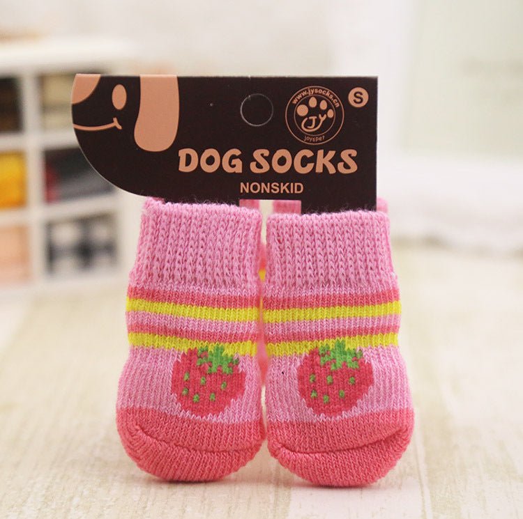 Pink dog socks with rainbow stripes and green character graphics; non-skid