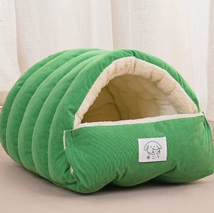 Green padded pet cave bed with front pouch and sherpa-lined arched opening