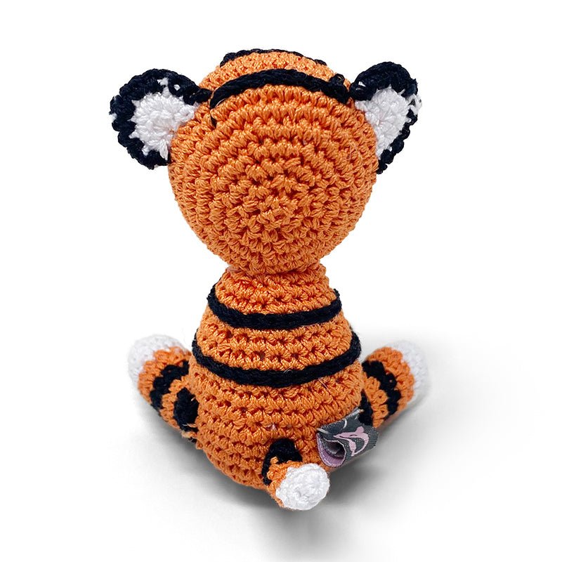 Crochet tiger plush toy, orange-and-black stripes, white paws, small tag on side