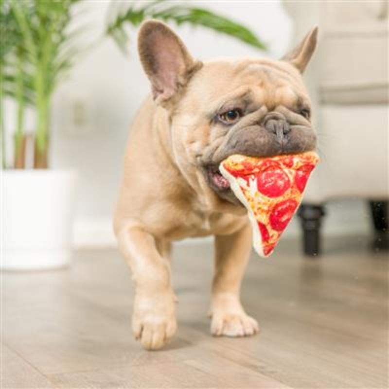 Plush taco slice dog toy in red and yellow, held in a bulldog’s mouth