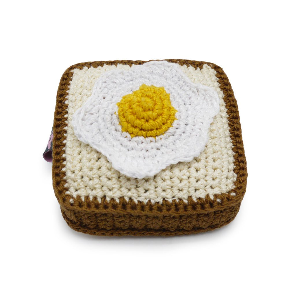 Crochet toast toy with white egg patch and yellow yolk, brown border