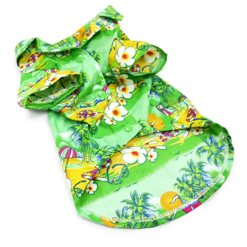 Green tropical dog shirt laid flat with colorful island print, short sleeves, and gathered seams