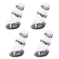 Set of waterproof dog shoes: clear boot covers with black straps and dark rubber soles