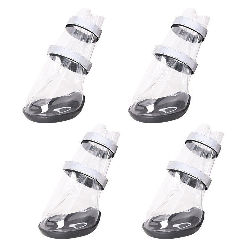 Set of waterproof dog shoes: clear boot covers with black straps and dark rubber soles