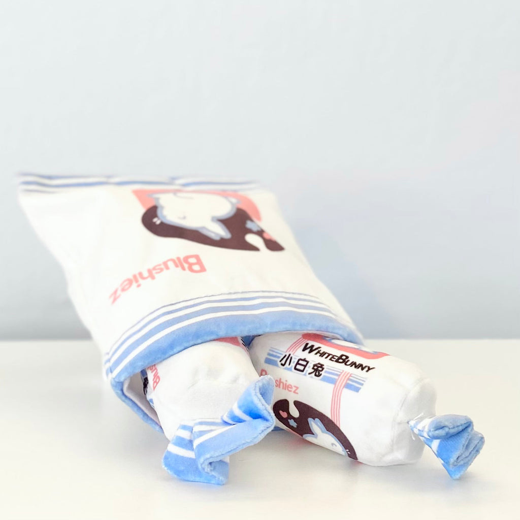 Rolled plush dog toy with blue-striped bunny patch and WhiteBunny label