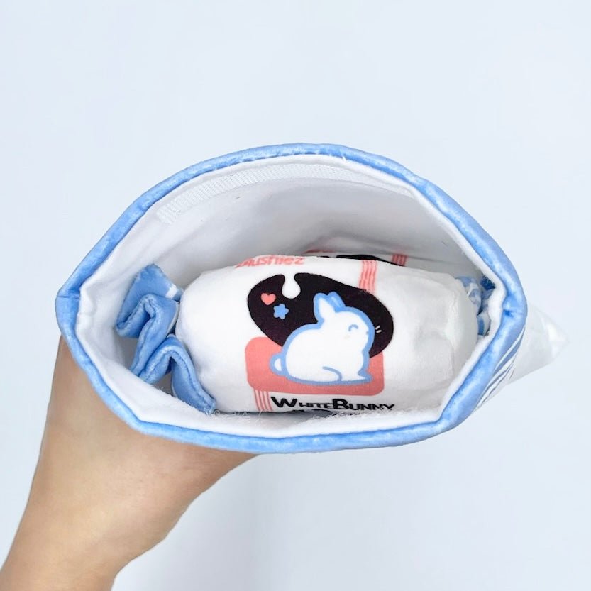 Plush dog toy pouch held open, showing bunny graphic inside with blue trim