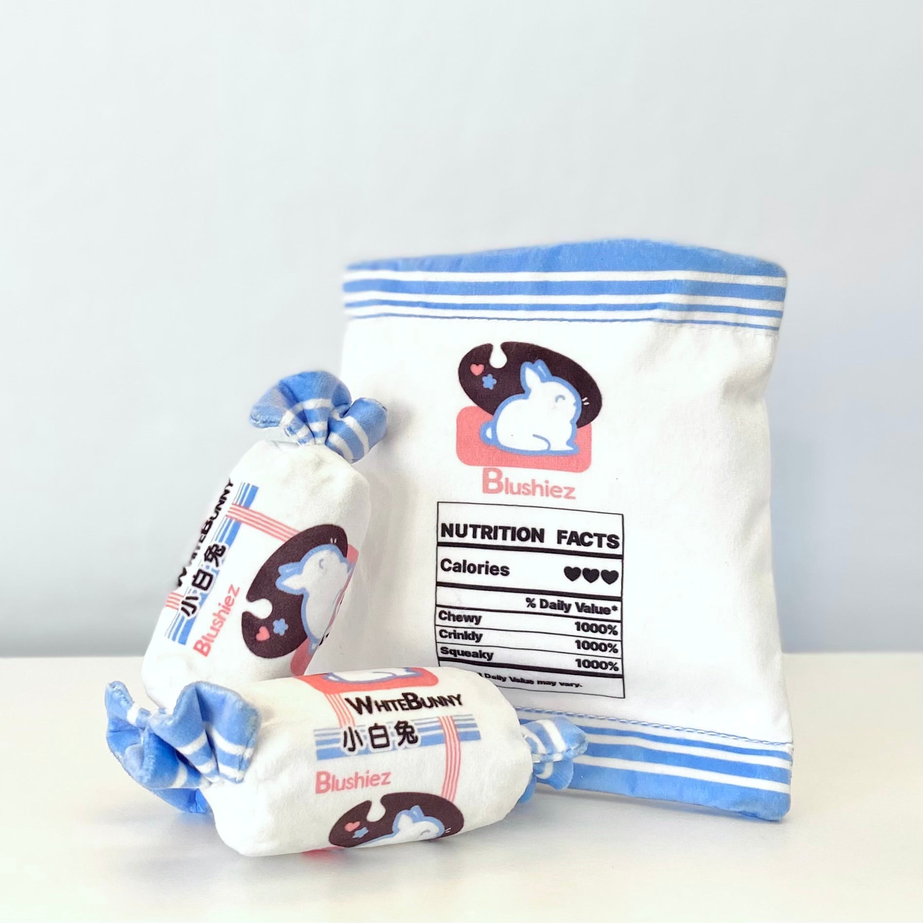 Plush dog toy set with blue-striped bunny pouch and two small rolled pieces