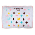 Chewy pet bed with light gray cover, pink border, and multicolor star paw print