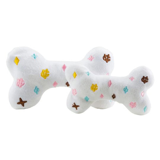 Chewy Vuiton white plush dog bone with colorful printed icons and centered strap patch