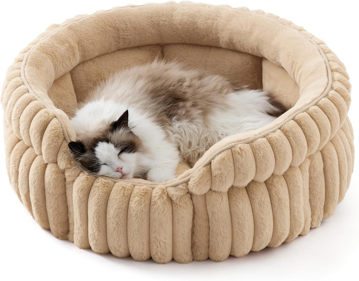 Sand beige round plush pet bed with cushioned rim; sleeping calico cat inside.