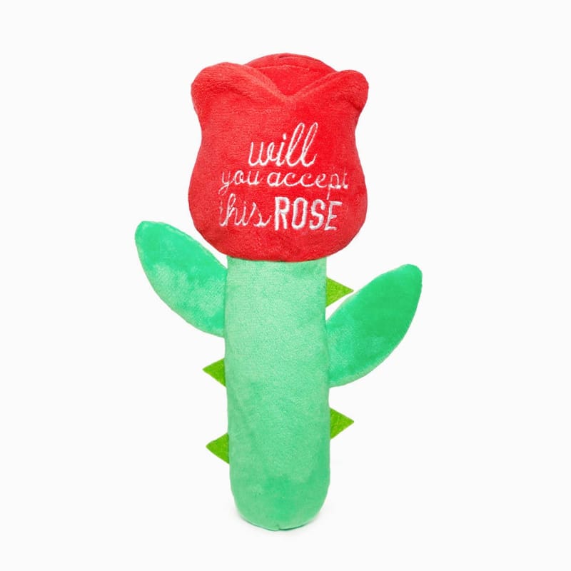 Plush rose-shaped dog toy with red head, green stem and leaves, text on top