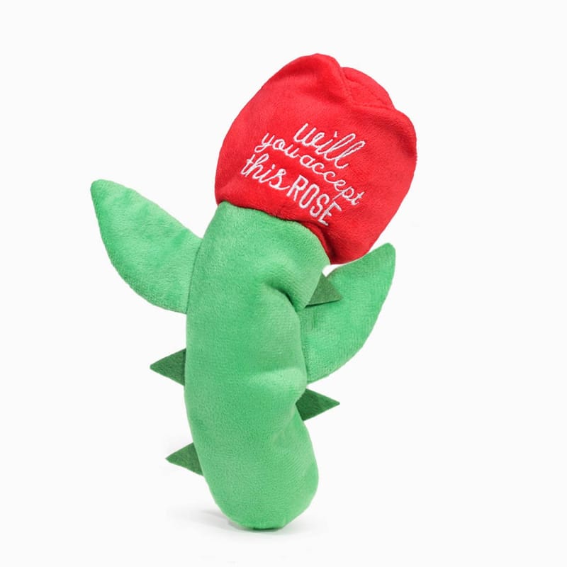 Plush rose-shaped dog toy with red head and green leaves, text on rose topper