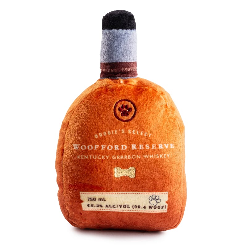 Plush squeaky dog toy bottle in orange with gray cap, front label and bone icon