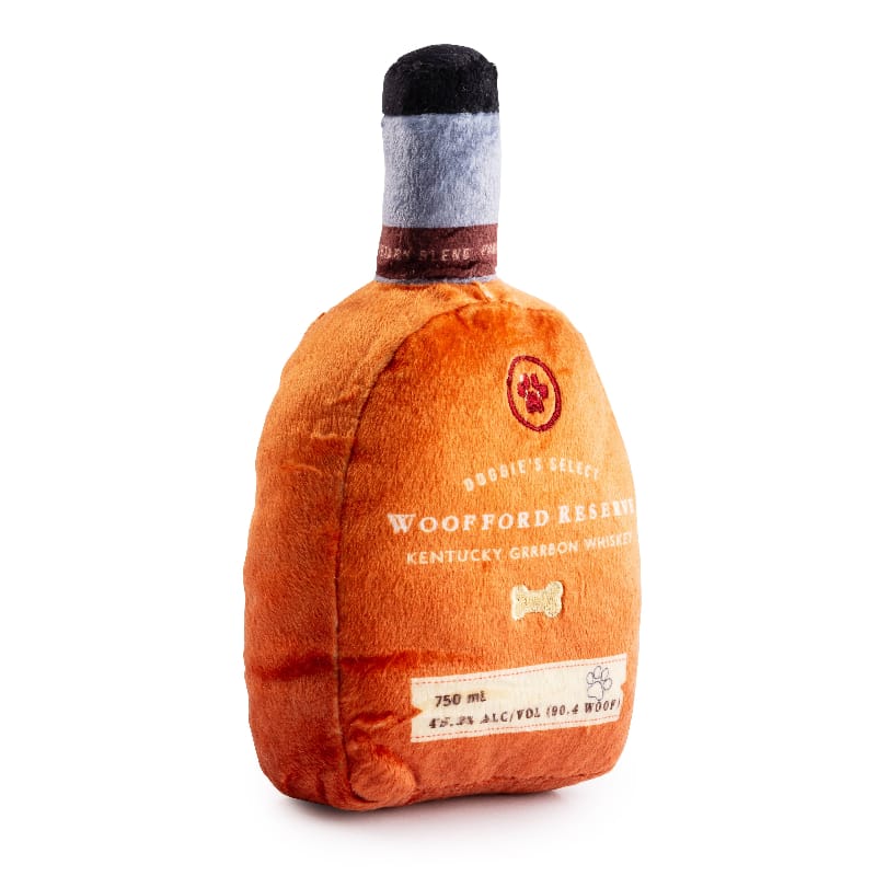 Plush squeaky dog toy bottle in orange with gray cap, side label with “750 ml”